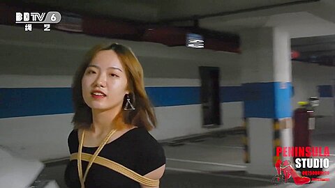 Young Chinese Girl Walks Around Carpark Tied Up