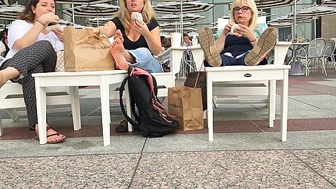 Three Female Strangers Reveal Their Feet While Eating At The Restaurant Outdoors...