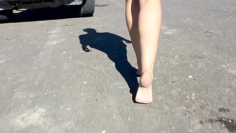 Woman In Short Shorts Walks Around Barefoot The Pavement...