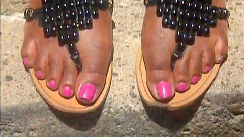 Wonderful Ebony Chick Wearing Flip Flops On Her Feet Outdoors...