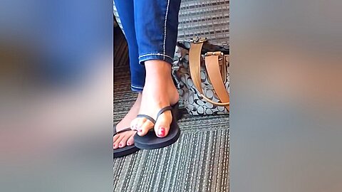 Jeans Wearing Flip Flops On Her Soft Feet With Red Nail Polish...