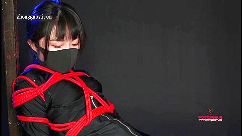 Ninja girl tied in red ropes...
