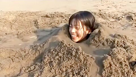 Girl buried in beach...